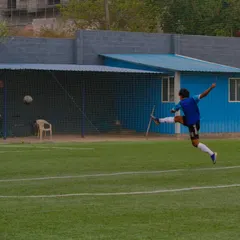 A player captured in a moment of pure power, executing a full-extension kick during a competitive match on our turf. This is the level of action our facility inspires.
