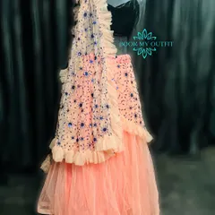 For a more modern look at a reception or sangeet, I have this beautiful peach ruffled lehenga. The tiered skirt and embroidered dupatta create a contemporary silhouette that is both elegant and easy to wear.