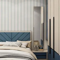 Detail of the chevron-patterned blue headboard and the sleek, full-length mirror attached to the wardrobe. These small touches add a layer of style and functionality to the room.