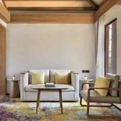 Our suites include a comfortable and stylish living area, furnished with a plush sofa and armchair. It is the perfect corner to read a book or simply relax after a day of exploring.