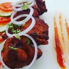 A close look at my B'luru Kebab. This is my take on the classic Bengaluru style chicken kebab, with its distinct red colour and incredibly tender texture. I serve it simply with fresh onion rings to let the flavour of the unique kebab marinade shine through.