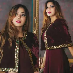 This modern Indo-Western outfit features a rich maroon velvet cape with striking gold embellishments. It's a perfect choice for a cocktail party, sangeet, or a stylish wedding guest look.