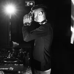 A candid black and white shot of me speaking into the microphone during a set. Whether it's a simple "hands up" or a shout-out to the guests of honor, my mic work is all about enhancing the vibe.