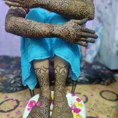 The complete bridal look, with detailed mehndi from fingertips to elbows and covering the feet. I love creating a design that flows beautifully for the entire wedding ceremony.
