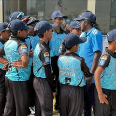 A coach giving instructions to the U-14 team during a break. These strategy sessions are crucial for learning and adapting during a match.