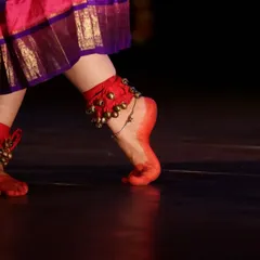 The sound of the ghungroo (salangai) is the heartbeat of a dancer. This close up shows the sacred anklets and the alta-dyed feet, which are central to the Gejjepuje ceremony and every performance.