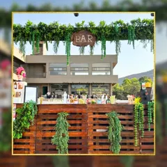 For a daytime event, we created this lush greenery bar setup. The rustic wooden pallet bar combined with fresh botanicals created a natural and elegant atmosphere.