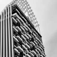 A black and white shot highlighting the clean lines and impressive facade of a luxury residential building in Bangalore. This is the kind of modern aesthetic I seek out for my clients.