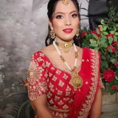 A beautiful party makeup look created by one of my senior artists. The classic red lip and soft gold eye makeup are a timeless combination that suits any festive occasion.