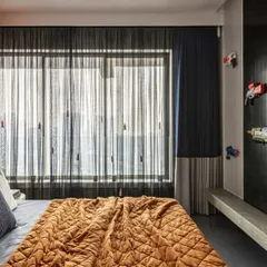 This son's bedroom in a Mumbai penthouse is inspired by the thrill of Nerf battles. I blended fun, functionality, and finesse with playful pops of color and smart storage solutions for a youthful yet luxurious edge.