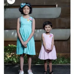 Two sisters showcasing how my crochet flower patches can adorn different styles of dresses. These custom appliqués add a coordinated yet unique touch to their outfits.