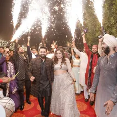 Making way for the happy couple with a grand entrance featuring dhol players and cold pyro. As an emcee, I build up the excitement on the mic just before they walk in.