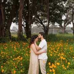 A tender moment in a field of flowers. For this outdoor pre-wedding shoot, I styled the couple in simple, neutral-toned outfits to keep the focus on their connection, with the natural landscape providing a beautiful, soft backdrop.