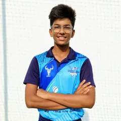 A portrait of our player Shwetansh RK against the backdrop of our professional net setup. Our facilities are designed to provide the best possible practice environment.