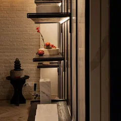 A detail shot of our custom shelving against a white brick-textured wall. The contrast between the rustic brick and the sleek, dark shelves creates a balanced composition, showcasing our ability to blend different materials effectively.