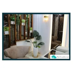 My work also extends to indoor plant styling. Here, I used a wooden partition with built-in shelves for potted plants and a large Monstera to bring the feeling of a lush garden into the living room.