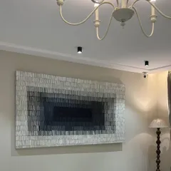 I love seeing my art transform a room. This 8-foot by 4-foot textured canvas, installed in a beautiful Gujarat residence, uses a gradient of grays to create depth and a sense of calm sophistication. It's a great example of how large-scale minimalist art can make a powerful statement.