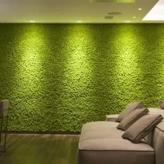 A full accent wall covered in artificial moss, creating a soft, vibrant, and sound-absorbing feature in this living room. The spotlights enhance the rich texture, making it a stunning focal point.