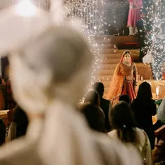 The groom's perspective of his bride's entrance. This over-the-shoulder shot captures the emotion and focus of this pivotal moment.