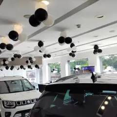 We use balloon clusters on the ceiling to add a festive touch throughout the entire showroom space. This approach ensures the celebratory atmosphere is felt in every corner of the NEXA dealership during their launch event.
