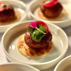 One of our most-loved dishes, the Lamb Galouti kebab. Melt-in-your-mouth tender lamb, infused with our secret spice blend, served on a mini saffron roti. It's a bite of modern Awadhi luxury that your guests will talk about long after the party ends.