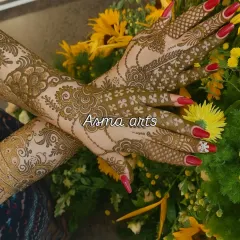 This design has a more open, flowing feel, with floral vines wrapping around the hands and arms. The negative space makes the patterns stand out beautifully. It's a modern take on traditional bridal henna.