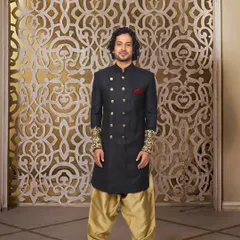 A standout look for a baraati. This black bandhgala with gold embroidered cuffs and buttons, paired with gold salwar pants, is all about festive swagger. It’s a look that’s both traditional and full of personality.