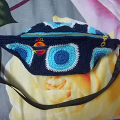 My Evil Eye themed travel pouch is a customer favorite. This crochet fanny pack is perfect for keeping your essentials safe while on the go, featuring a durable zipper and an adjustable strap for comfort.