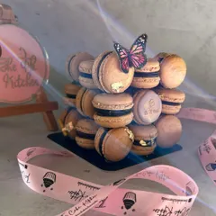This view highlights the cube-like structure of the macaron tower. It's a modern and stylish way to serve these classic French treats at your wedding or engagement party.