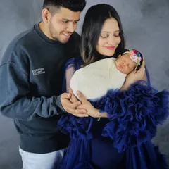 A complete family portrait with both parents holding their newborn. I love capturing the way new parents look at their baby and each other during these first few weeks.
