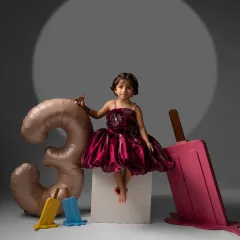 A sweet, direct-to-camera look during her third birthday photoshoot. Even in a fun, themed setup, we make sure to capture those simple, beautiful portraits that you'll treasure.