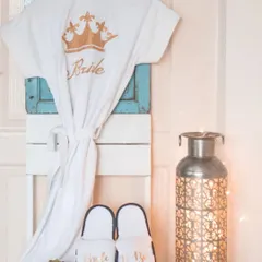 I offer personalized bridal robes and slippers for the bride and her crew. This white robe features a gold crown and "Bride" embroidery, making for great getting-ready photos on the wedding day.