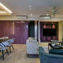 Color is a powerful tool for storytelling. In this Thane residence, I used a bold grape hue in both high-gloss and matte finishes to create a living area that is dramatic and artistic, balanced by soft, neutral fabrics and patterned accents.