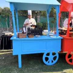 My chefs at colorful live food carts during an outdoor event. These interactive stations bring energy and a street-food vibe to any party, serving up delicious food on the spot.