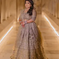 A beautiful full-length portrait of the bride in her elegant engagement lehenga, looking radiant and happy.