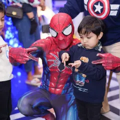 Imagine your child's excitement meeting their favorite hero. Our exclusive party packages can include a mascot visit, like this awesome interaction with Spider-Man, creating a core memory for your little one.