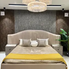 Your bedroom should be a retreat. We designed this grand, fully upholstered bed to be the centerpiece of your sanctuary. Notice the channel-tufted headboard and the elegant proportions, all crafted in our workshop to create a feeling of pure luxury.