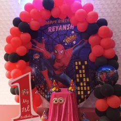 A close-up of our action-packed Spiderman theme decoration. The setup includes a custom backdrop, a red and black balloon arch, and a themed cake table, perfect for a superhero's first birthday.
