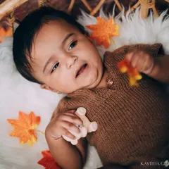 A favorite shot of mine from a milestone session. The baby's sweet, contemplative expression and the warm, rustic theme come together beautifully in this portrait.