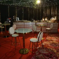 We create a complete bar experience, including elegant high-top tables and seating. This allows the bar area to become a social hub where guests can comfortably mingle and enjoy their drinks.