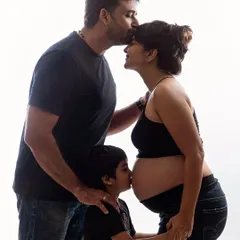 A family's love. Dad kisses mom's forehead while big brother gives the baby bump a sweet kiss. These are the tender, heartfelt moments that truly matter.