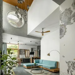 This double-height lounge is the heart of the home, designed to connect spaces, people, and nature. I used a mix of honest materials like a random rubble stone wall and a warm wooden ceiling to create a space that feels both grand and grounded.