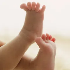 A little stretch. This photo captures the sweet, unposed movement of a newborn's feet, a memory of their sleepy, curly stage.