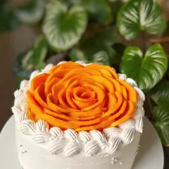 A close up of the mango rose design. You can see the vibrant color and freshness of the Alphonso mango, which is the star of this simple and elegant eggless cake.