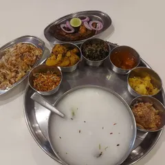 This is my authentic Pakhala Thali, a cherished meal from Odisha that I prepare for special occasions. It features fermented rice (Pakhala) served with an array of traditional side dishes like fried fish, various vegetable fries (bhaja), and chutneys.
