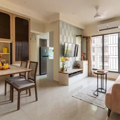 We specialize in smart solutions for city living. This custom-built unit features a fold-down dining table that seamlessly tucks away, transforming the living area and maximizing floor space in this modern Mumbai apartment.