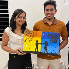 Art is the perfect date night. This happy couple is showing off their completed diptych painting, a two-part canvas that creates one beautiful picture. Our Sip and Paint sessions are a fantastic way to connect and create something meaningful together.