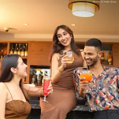 Laughter and good times are always on the menu at Neptune. Here, friends gather at the bar to share drinks and make memories.
