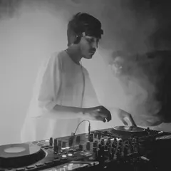 Caught in the zone during a set for Dance Ok Please. For me, it's about creating an atmosphere where the music takes over, blending deep cuts and heavy basslines to keep the floor moving. This black and white shot perfectly captures that smoky, intense club vibe.