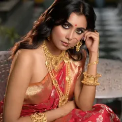 A seated portrait from the Sananda magazine cover shoot. This pose showcases the magnificent gold jewelry and the rich texture of the banarasi saree.